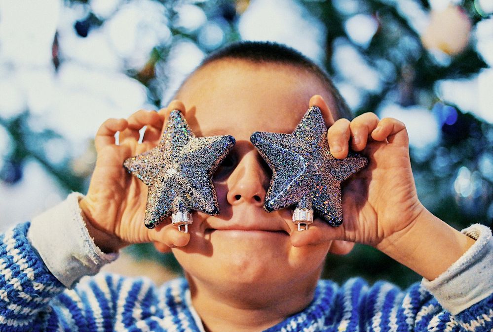 Large_MS PPT_Web-Little boy with star christmas ornaments in front of eyes.  (1).jpg
